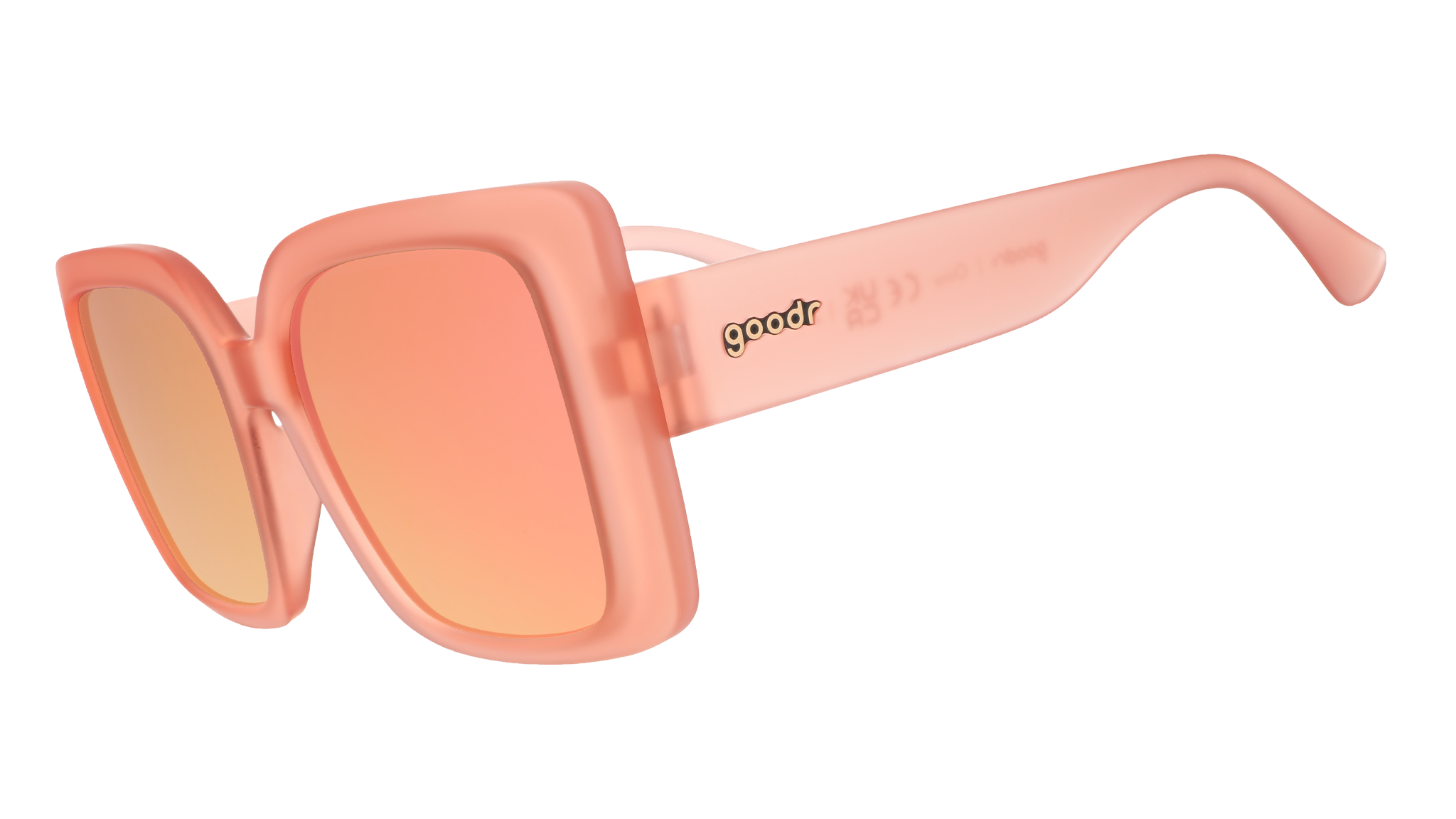 Three-quarter angle view of oversized square sunglasses in coral pink with champagne gold reflective lenses.