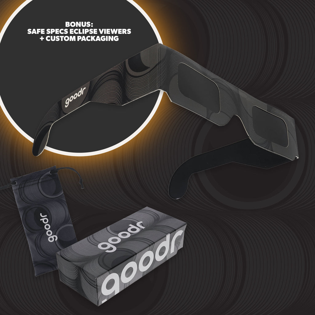 Black and gray eclipse glasses and custom packaging against a gray background.