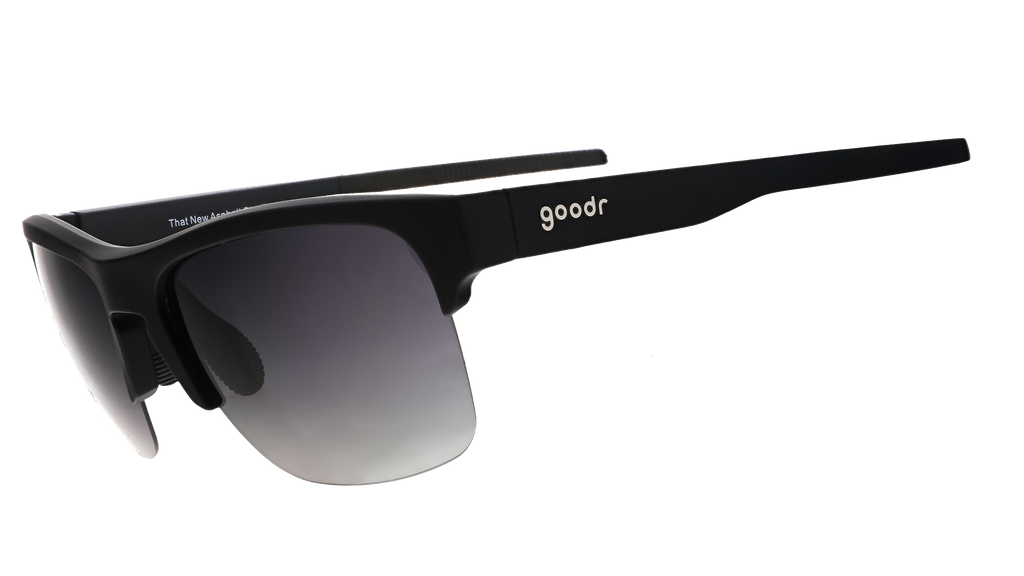Three-quarter angle view of black half-rim sunglasses with a dual-lens wrap and polarized black gradient lenses and black silicone grips on the inner right arm.