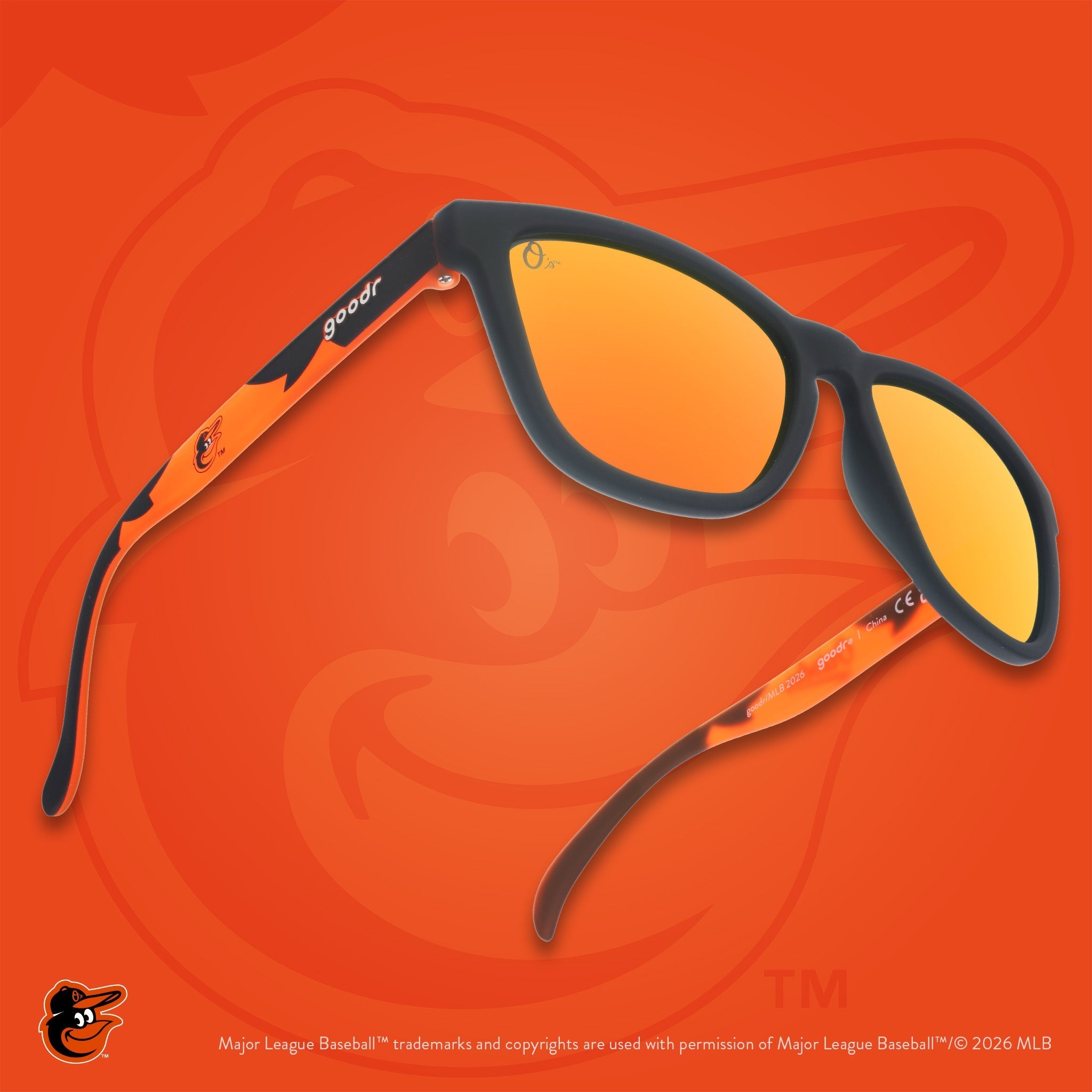 Three-quarter angle view of Oriole's shades featuring the bird logo on the arm. The orange background features the O's logo.