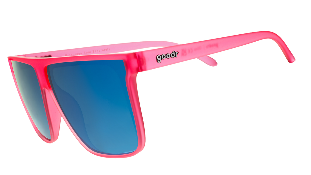 Three-quarter view of pink wide-fit, oversized flat-top sunglasses with blue reflective lenses.