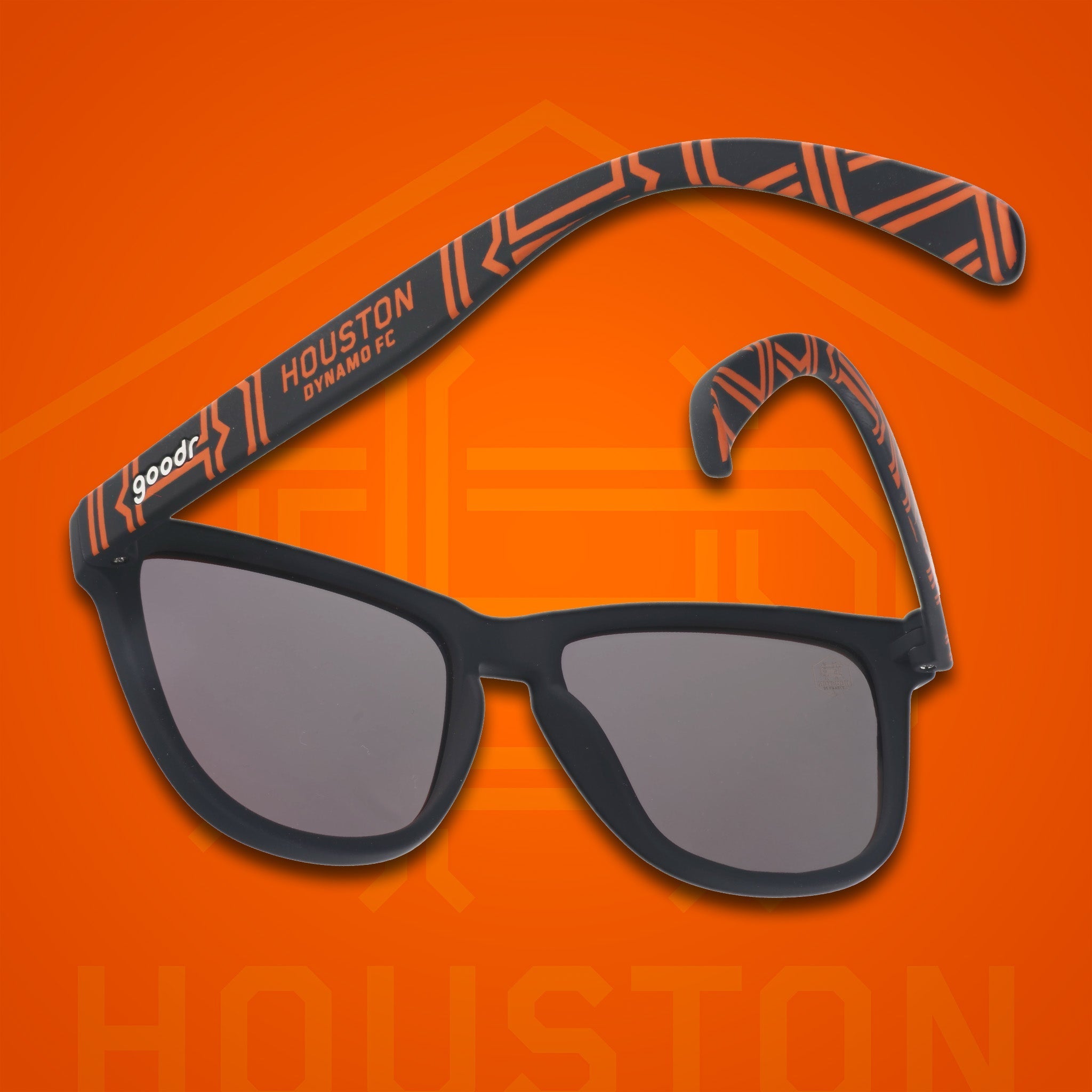 Three-quarter angle back view of MLS Houston Dynamo FC shades. Black+orange frames. Amber reflective lenses.