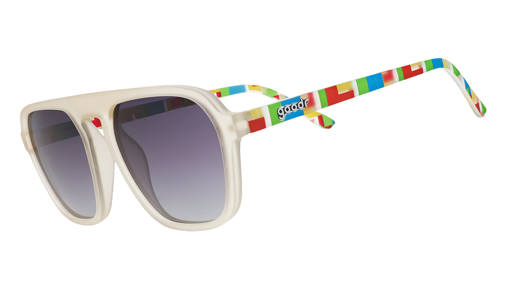 Light gray sunglasses with purple gradient lenses and colorful geometric temple patterns on blue.