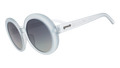 Three-quarter angle view of oversized round sunglasses with translucent blue frames and silver reflective gradient lenses.