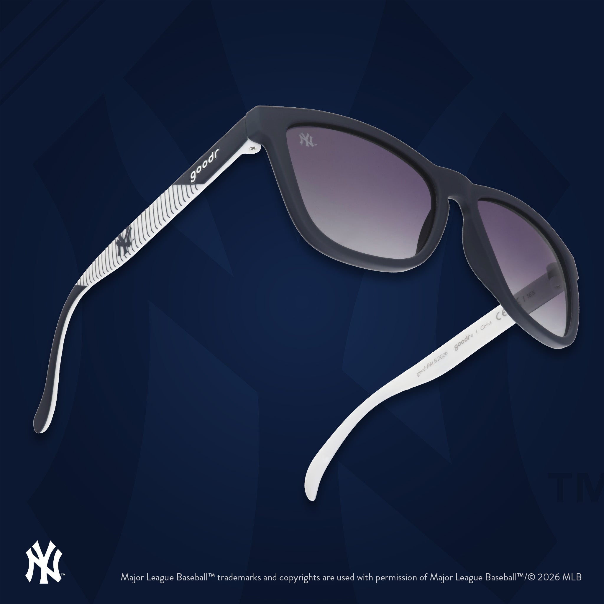 Three-quarter angle view of a pair of Mets sunnies floating against an orange background featuring the team's NY logo.