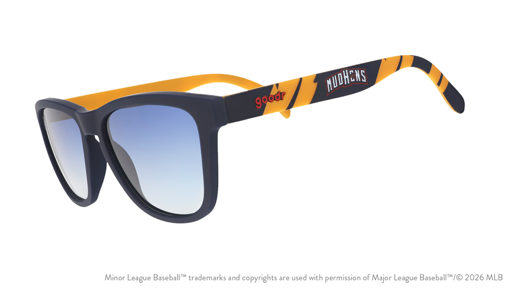 Three-quarter angle view of shades. Blue frames w/ a yellow pattern, Mud Hens on temples + blue gradient lenses.