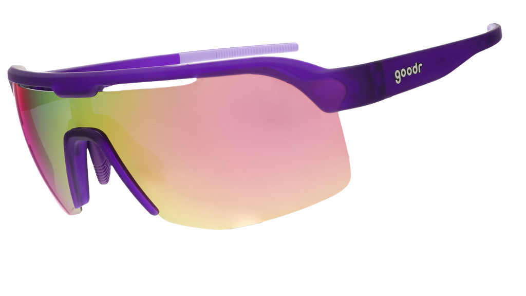 The image shows a pair of sporty wraparound sunglasses with a sleek purple frame and reflective lenses that transition from pink to yellow hues.