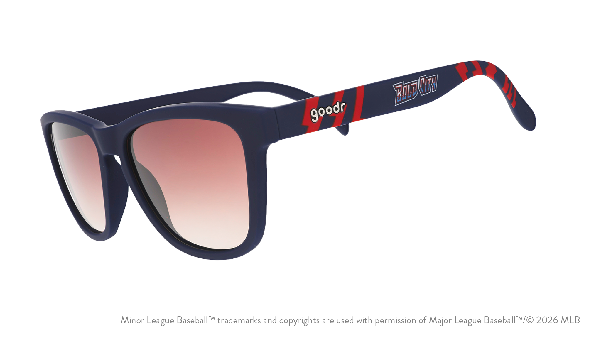 Three-quarter angle view of shades tilted down. Blue + red frames w/ Bold City on temples. Brown gradient lenses.