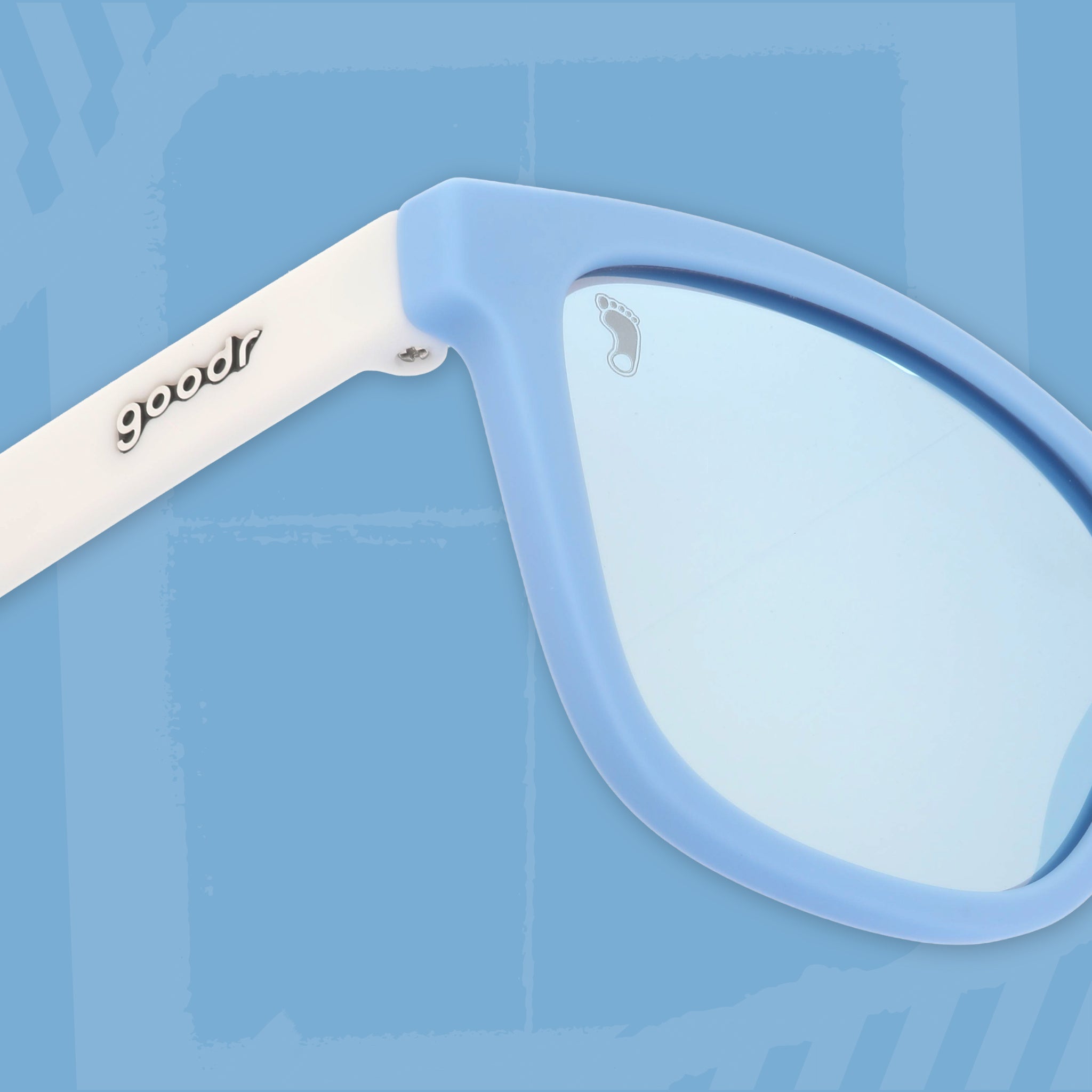 Close-up three-quarter angle view of Carolina blue and white sunglasses featuring ice blue reflective lenses on a light blue background.