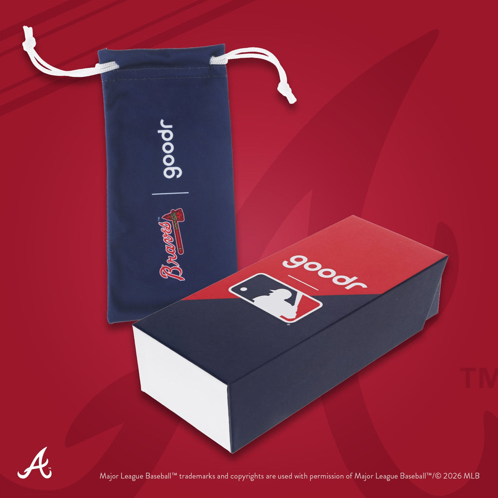 Photograph of custom packaging, featuring a navy microfiber bag with script and tomahawk team logo and MLB-themed box.