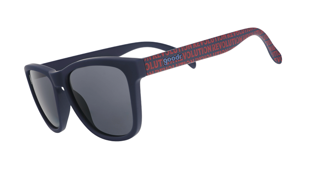 Three-quarter angle view of MLS New England Revolution shades tilted down. Black+red frames. Black non-reflective lenses.