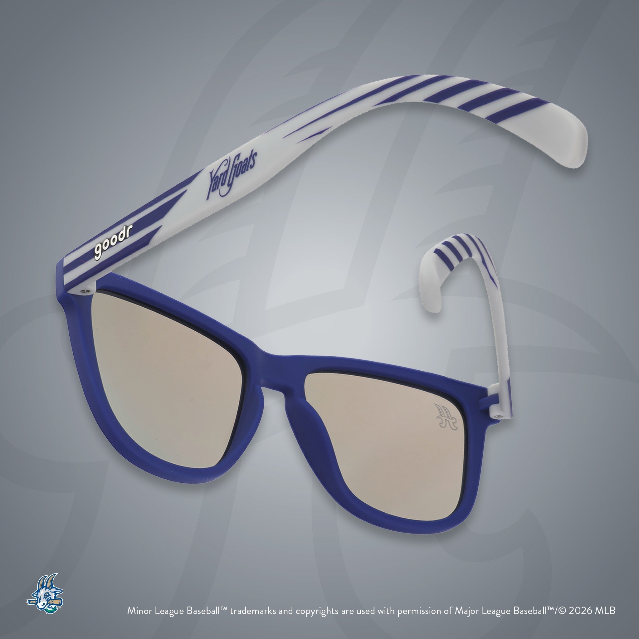 Back view of sunglasses tilted down. Blue + gray frames w/ Yard Goats on temples. Teal reflective lenses.