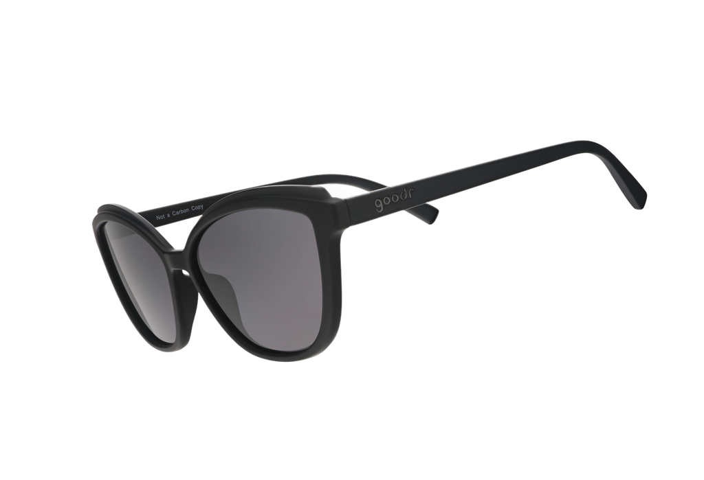 Black sunglasses with dark lenses on a white background