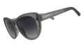 Three-quarter angle view of translucent gray cat-eye sunglasses with black gradient lenses.