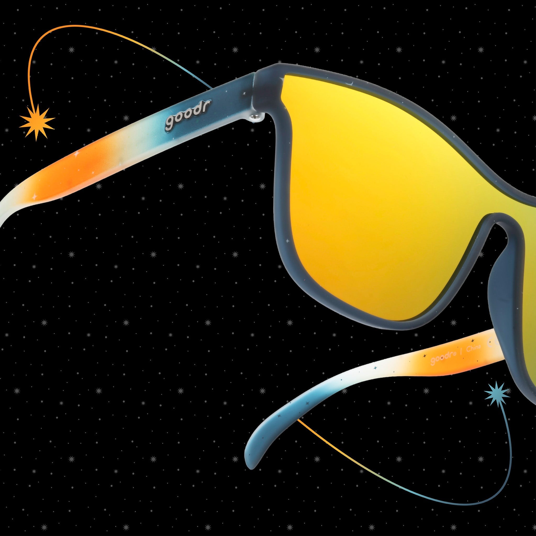 Close-up three-quarter view of translucent blue and orange ombre VRGs featuring a cosmos design and a reflective amber lens.