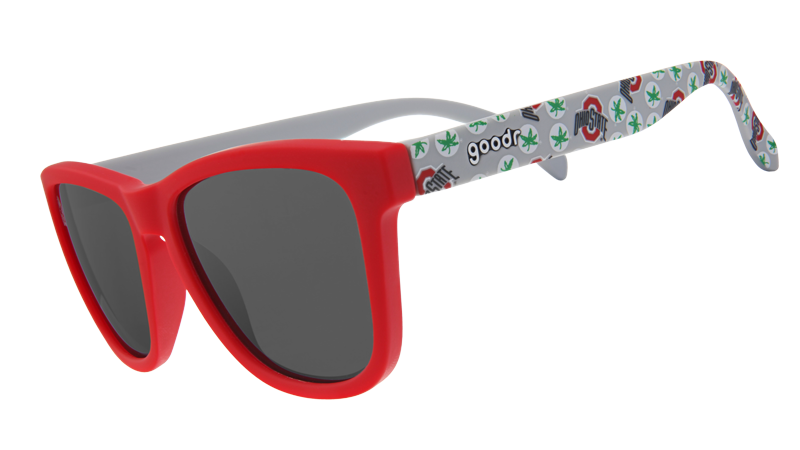Sunglasses with a bright red frame and dark lenses, paired with white arms adorned with Ohio-themed designs in green and red.
