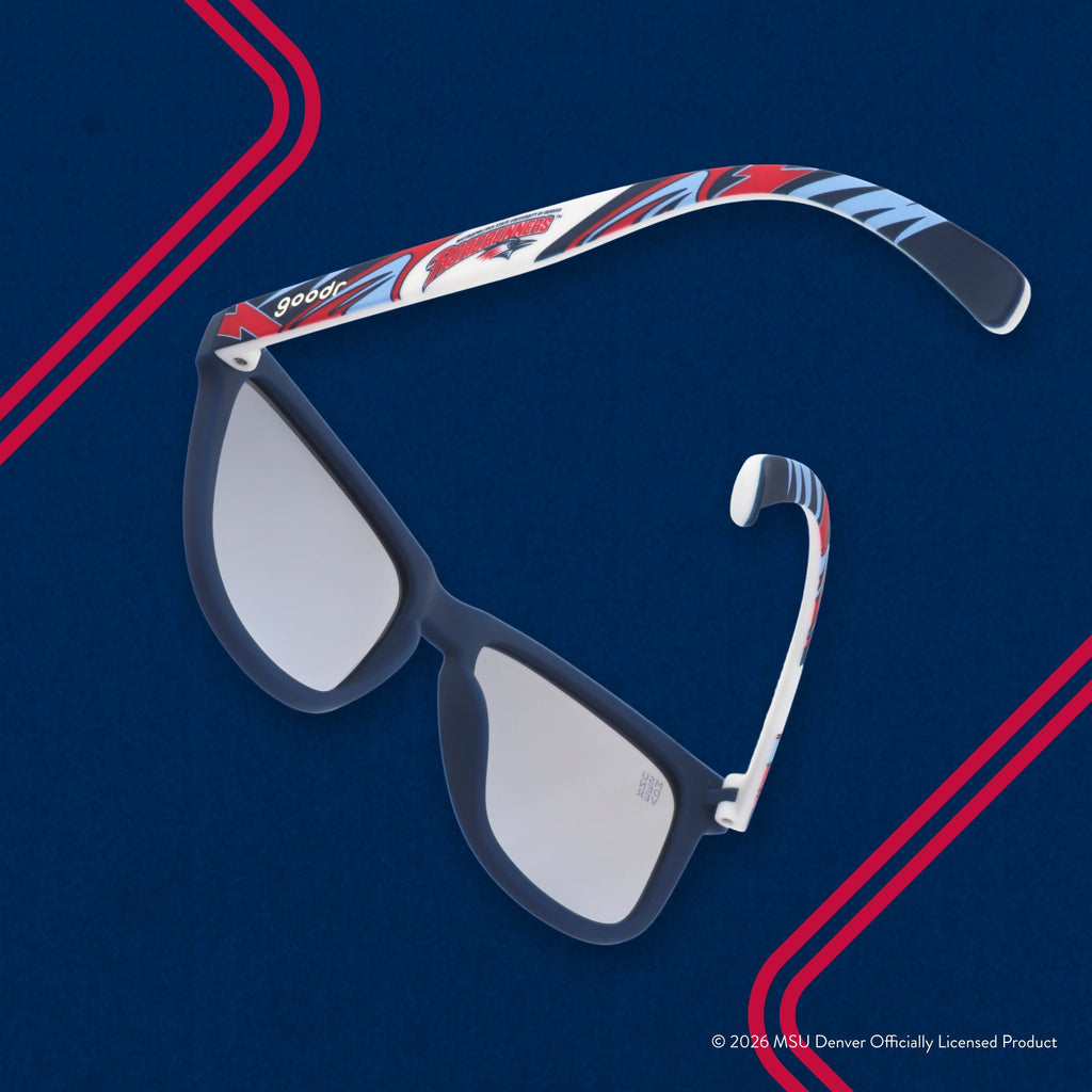 Back view of sunglasses tilted down. Solid blue frames w/ a red + white Roadrunners pattern + blue reflective lenses.
