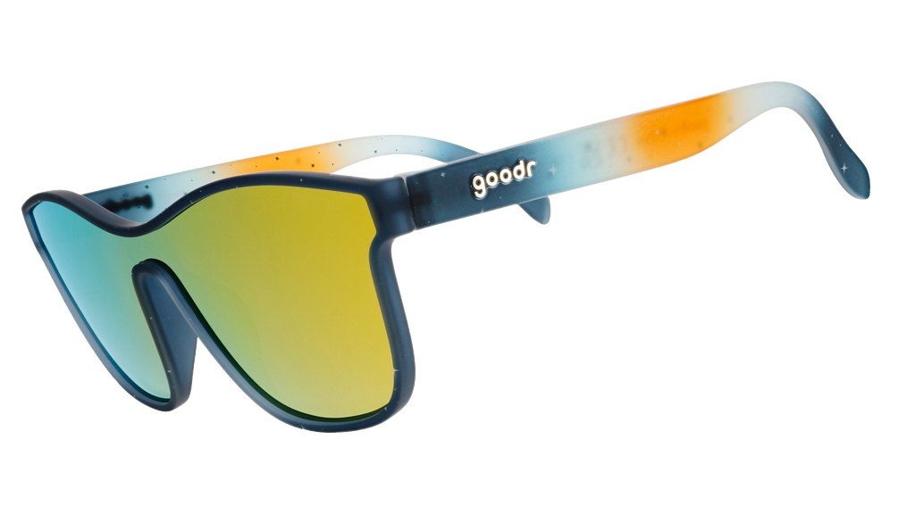 Three-quarter view of translucent blue and orange ombre VRG frames featuring a cosmos design and amber reflective lens.