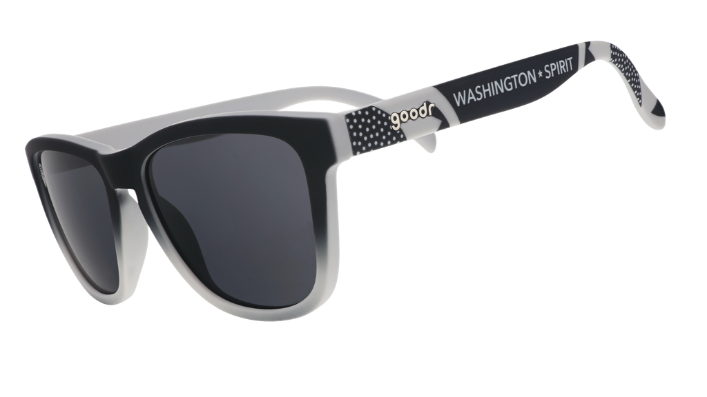 Three-quarter angle view of black and gray gradient sunglasses featuring black polarized lenses and the Washington Spirit logo.