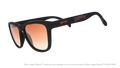 Three-quarter angle view of shades tilted down. Black frames w/ Isotopes + logo on temples. Amber reflective lenses.