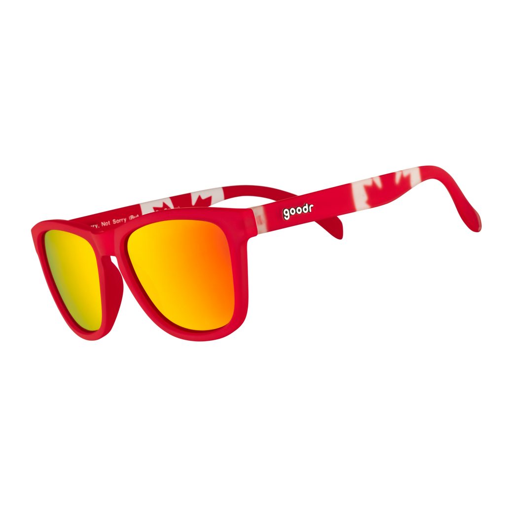 Three-quarter angle view of red shades w/ a Canadian flag pattern+burnt orange reflective lenses on a white background.