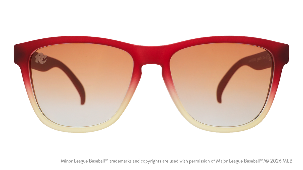Front view of sunglasses. Red + brown front frame. Amber gradient lenses. River Cats logo etching in top corner of lens.