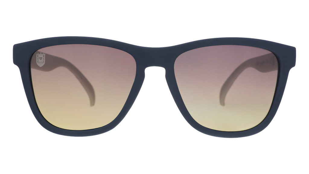 Front view of black and white sunglasses with gray-to-yellow ocean gradient lenses and the Seattle Reign logo etched into the right lens.