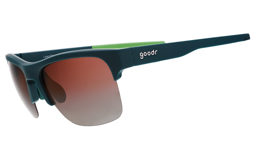 Three-quarter angle view of solid green half-rim sunglasses featuring polarized rose gradient lenses and lime green silicone grips on the inner right arm.