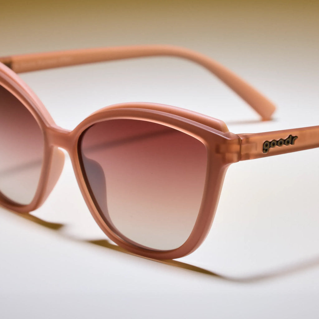 Sunglasses with a gradient brown lens on a light background