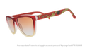 Three-quarter angle view of sunglasses tilted down. Brown + red frames w/ RC on temples + amber gradient lenses.