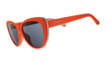 Three-quarter angle view of red cat-eye sunglasses with black non-reflective lenses.