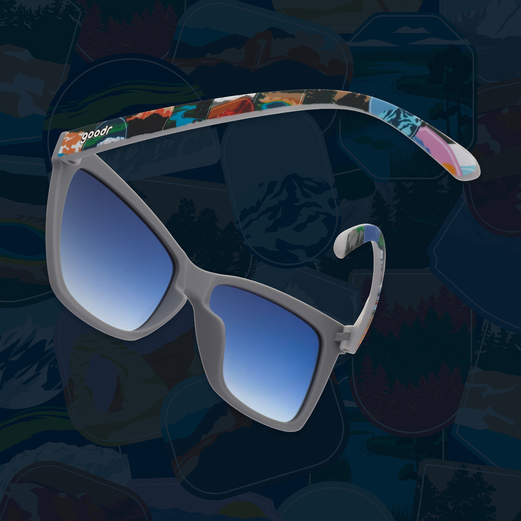 Side view of gray sunglasses with blue gradient lenses and colorful National Park Foundation temples.