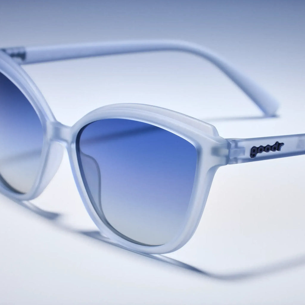 Blue gradient sunglasses with 'goodr' branding on a light blue background