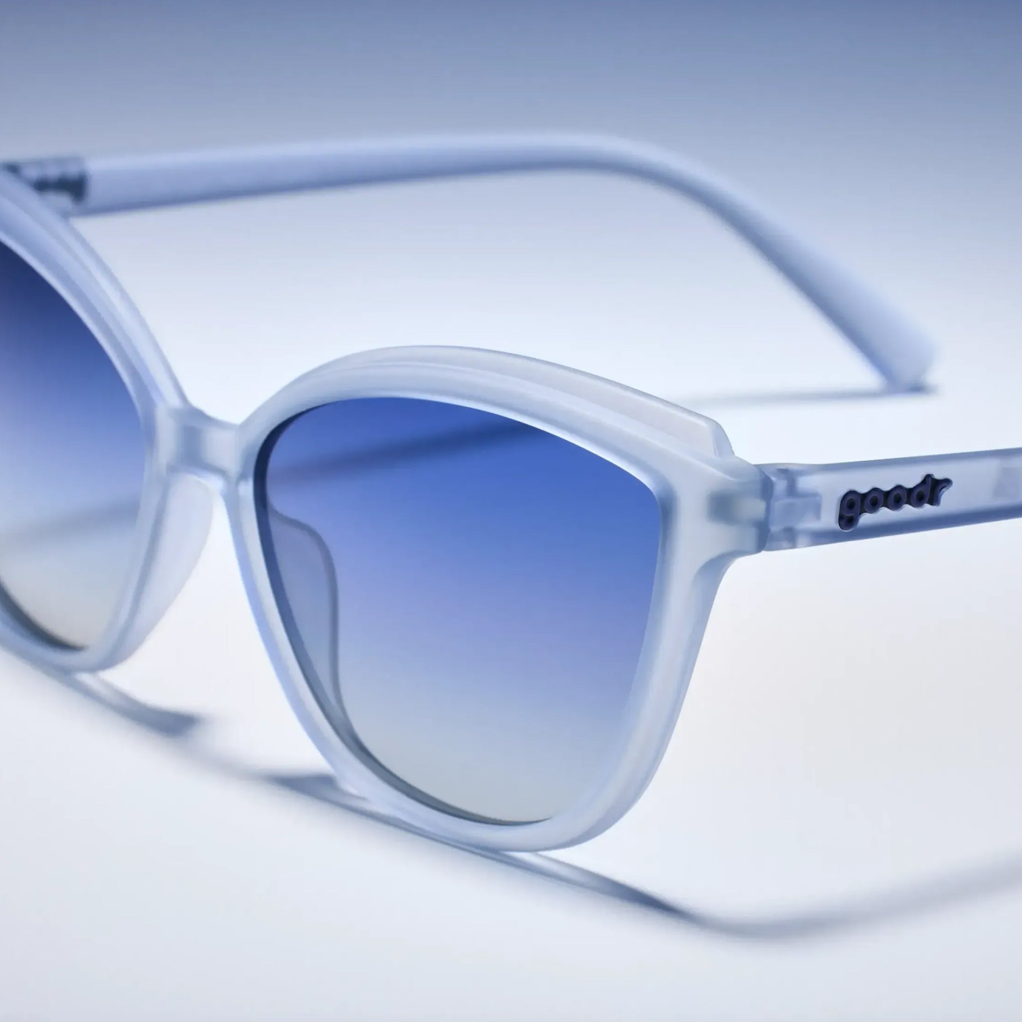 Blue gradient sunglasses with 'goodr' branding on a light blue background