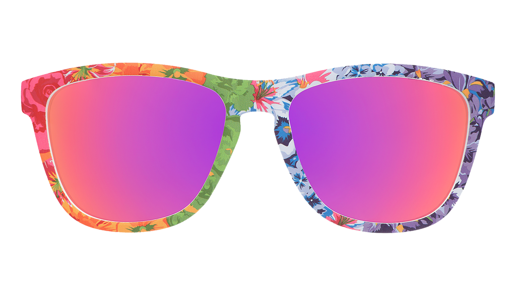 Front view of colorful floral print goodr sunglasses with purple reflective sunglasses.