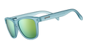 Three-quarter angle view of square-shaped sunglasses with light blue translucent frames and gold reflective lenses.