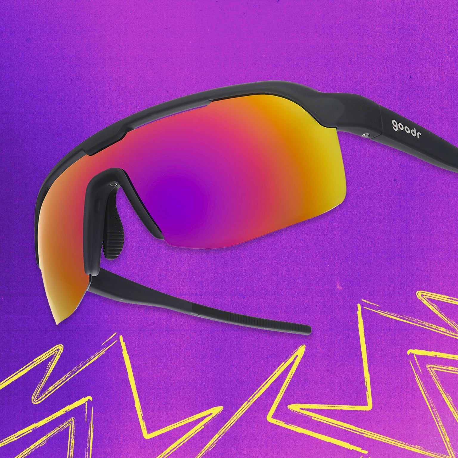 Three-quarter angle view of black shield sunnies with purple reflective wrap lenses tilted down on a purple background.