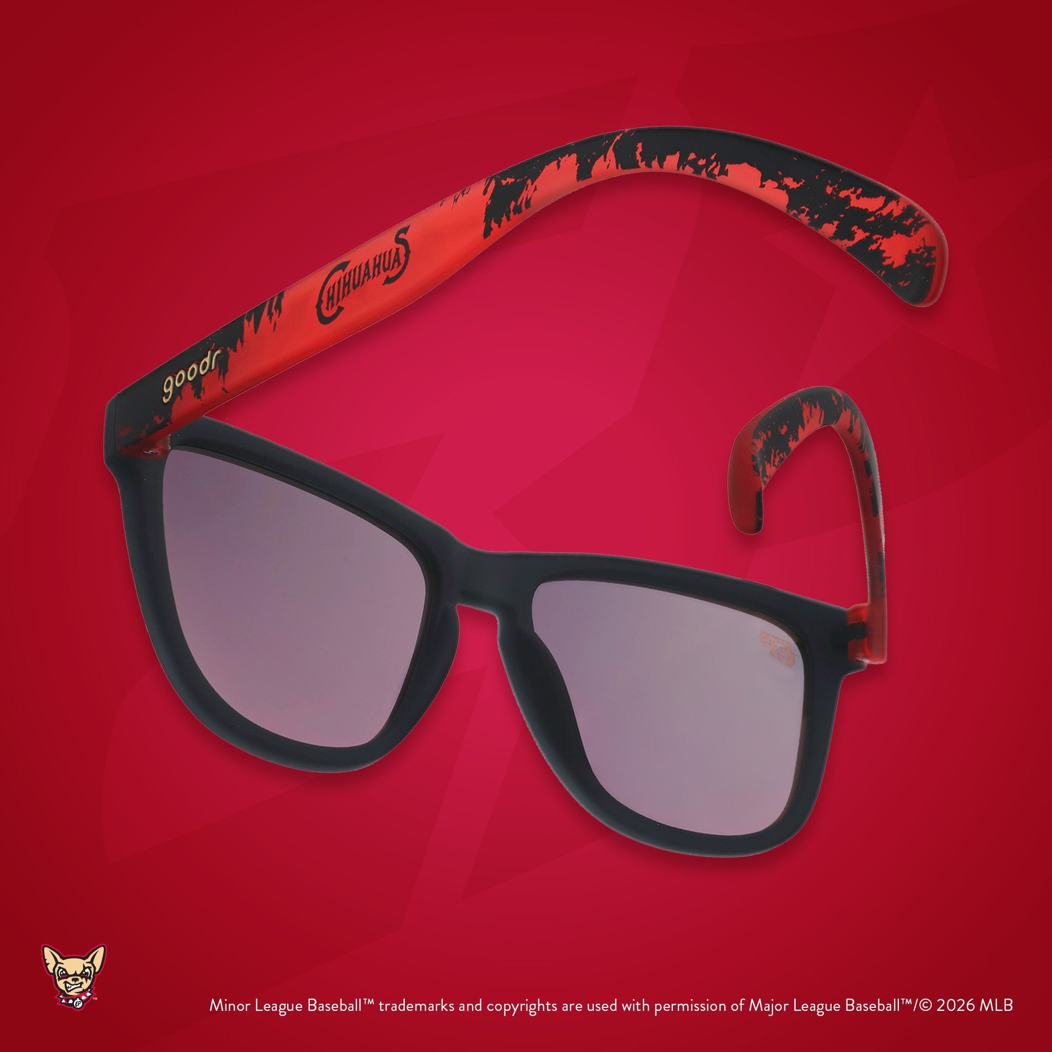 Back view of sunglasses tilted down. Dark gray+red frames w/ Chihuahuas on temples. Amber reflective lenses.