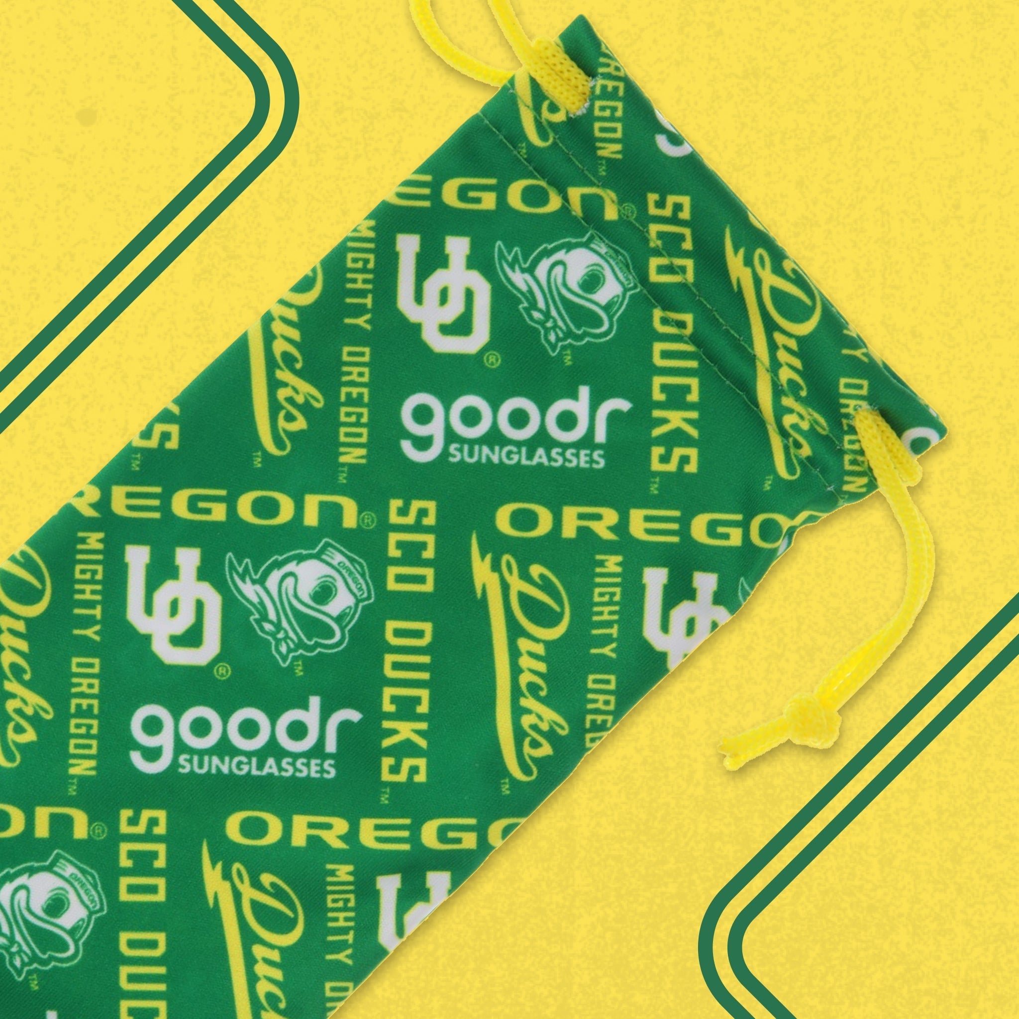 Green, yellow, and white microfiber Oregon Ducks sunglasses pouch shown on a yellow backdrop.