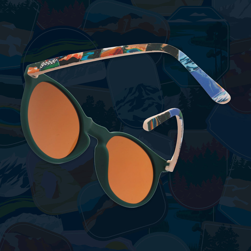 Side view of green round sunglasses with brown non-reflective lenses and colorful National Park Foundation temples.
