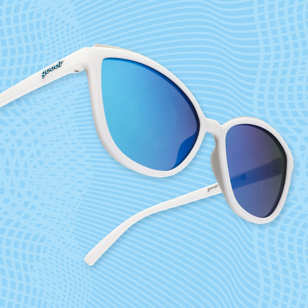 Side view of white cat-eye sunglasses with light blue mirrored lenses and minimalist white frames.
