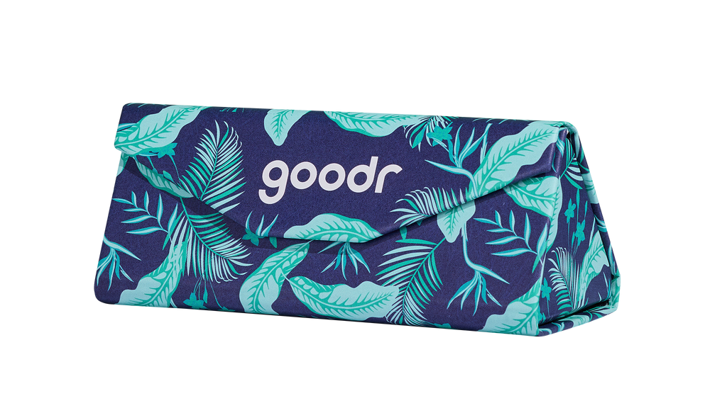 Three-quarter angle view of the Enter the Fold navy and teal tropical-print sunglasses case showing it expanded and closed shut.