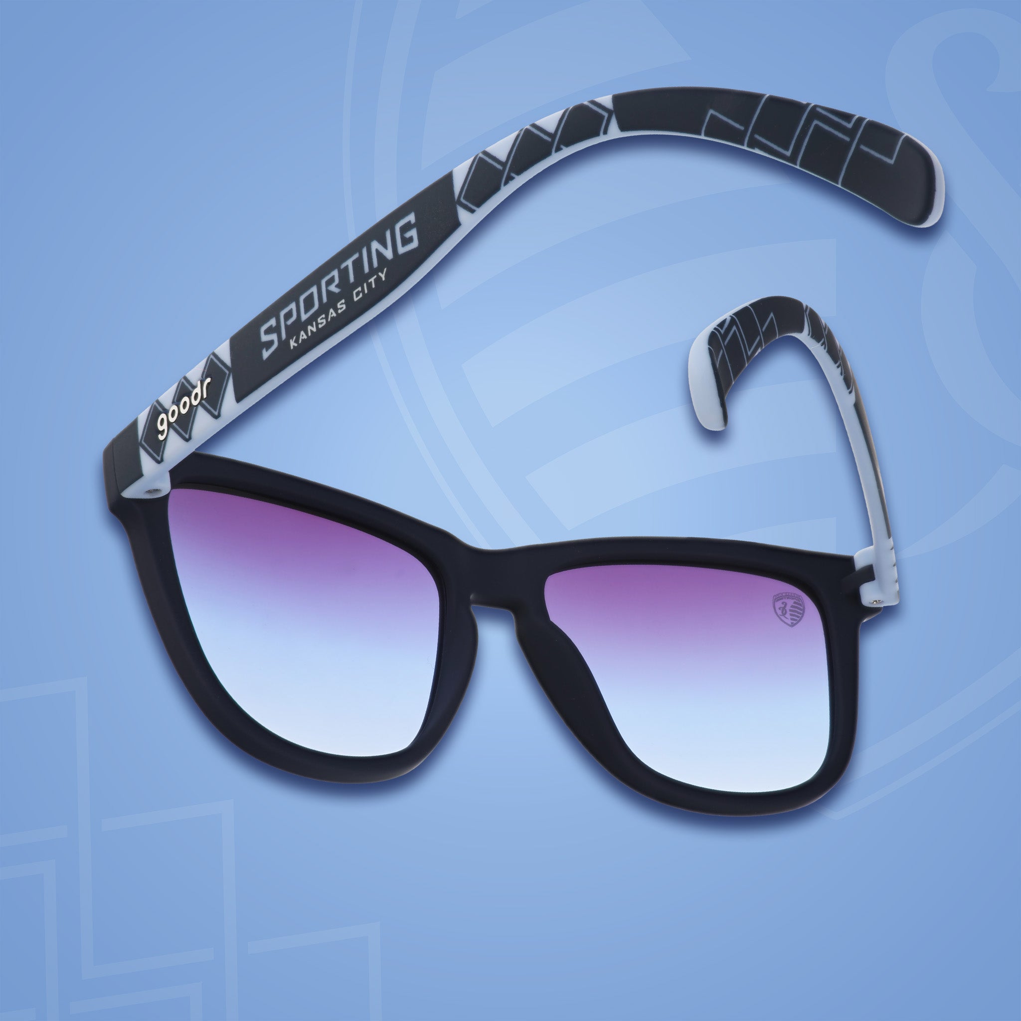 Three-quarter angle back view of MLS Sporting KC shades on a blue background. Navy+blue frames. Dark blue lenses.