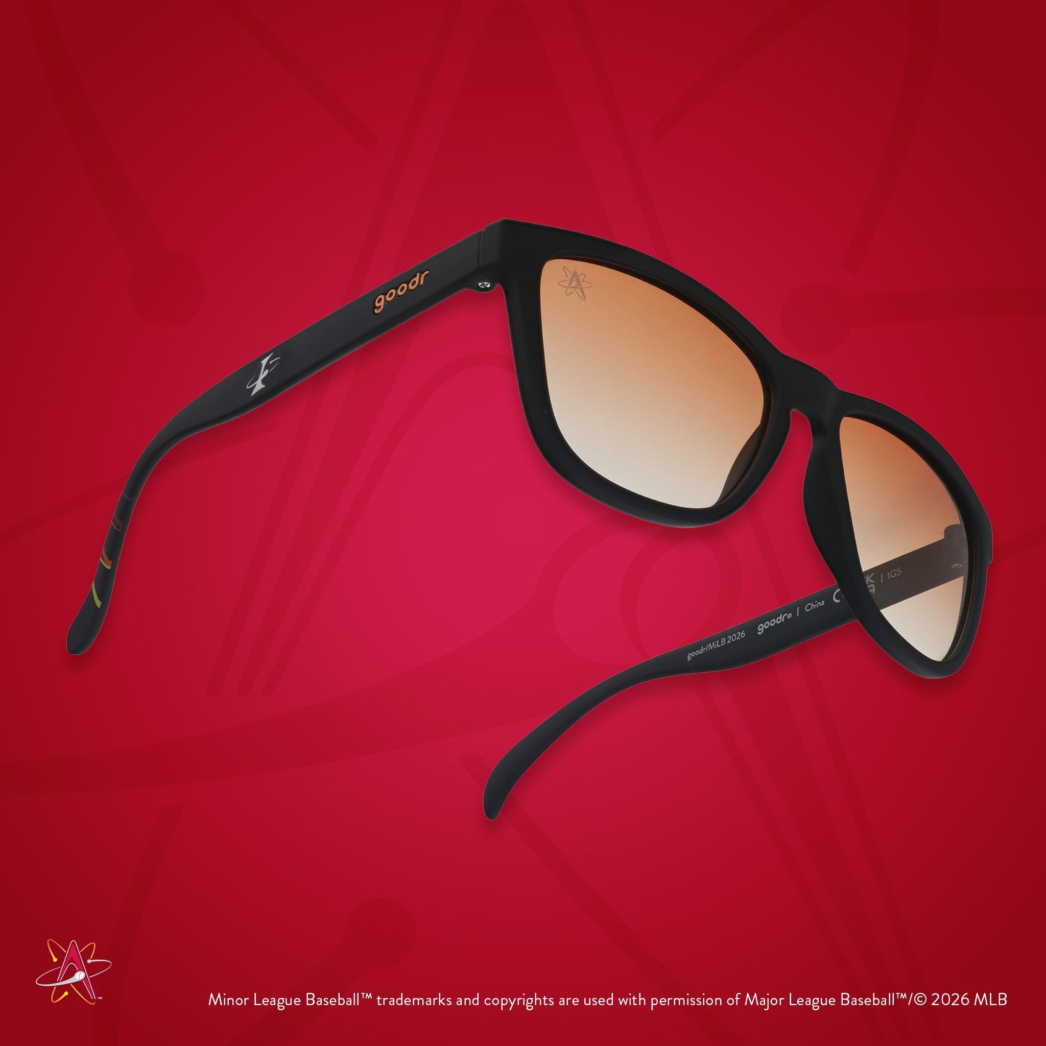Three-quarter angle view of shades tilted up. Black frames w/ Isotopes logo on temples. Amber reflective lenses.