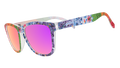 Three-quarter angle view of colorful floral print goodr sunglasses with purple reflective lenses.