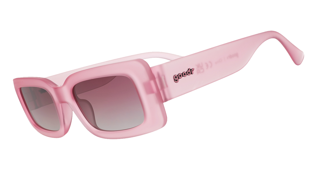 Three-quarter angle view of translucent rectangular pink Luxe G sunglasses with purple gradient lenses.