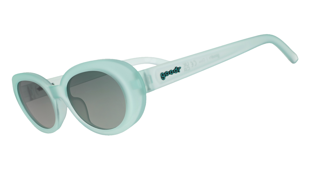 Three-quarter angle view of translucent pale green oval Beat G sunglasses with green gradient lenses.