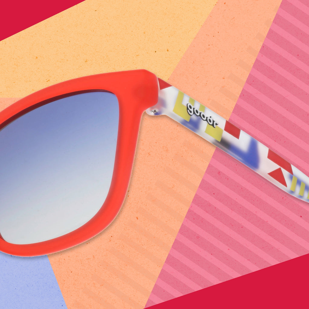 Close-up view of the temple on a pair of red sunglasses with multi-colored arms depicting maritime signal flags.
