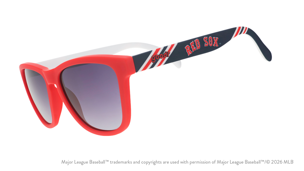 Three-quarter angle view of a pair of red, white, and navy sunnies featuring the Red Sox's team name logo on the arm.