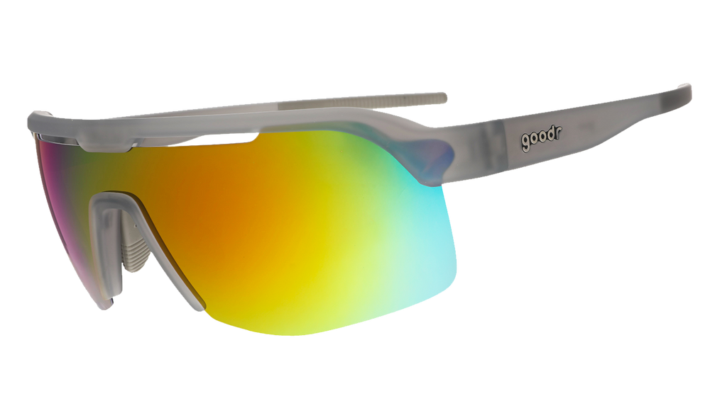 Three-quarter angle view of gray shield sunglasses with orange reflective wrap lenses tilted down on a white background.